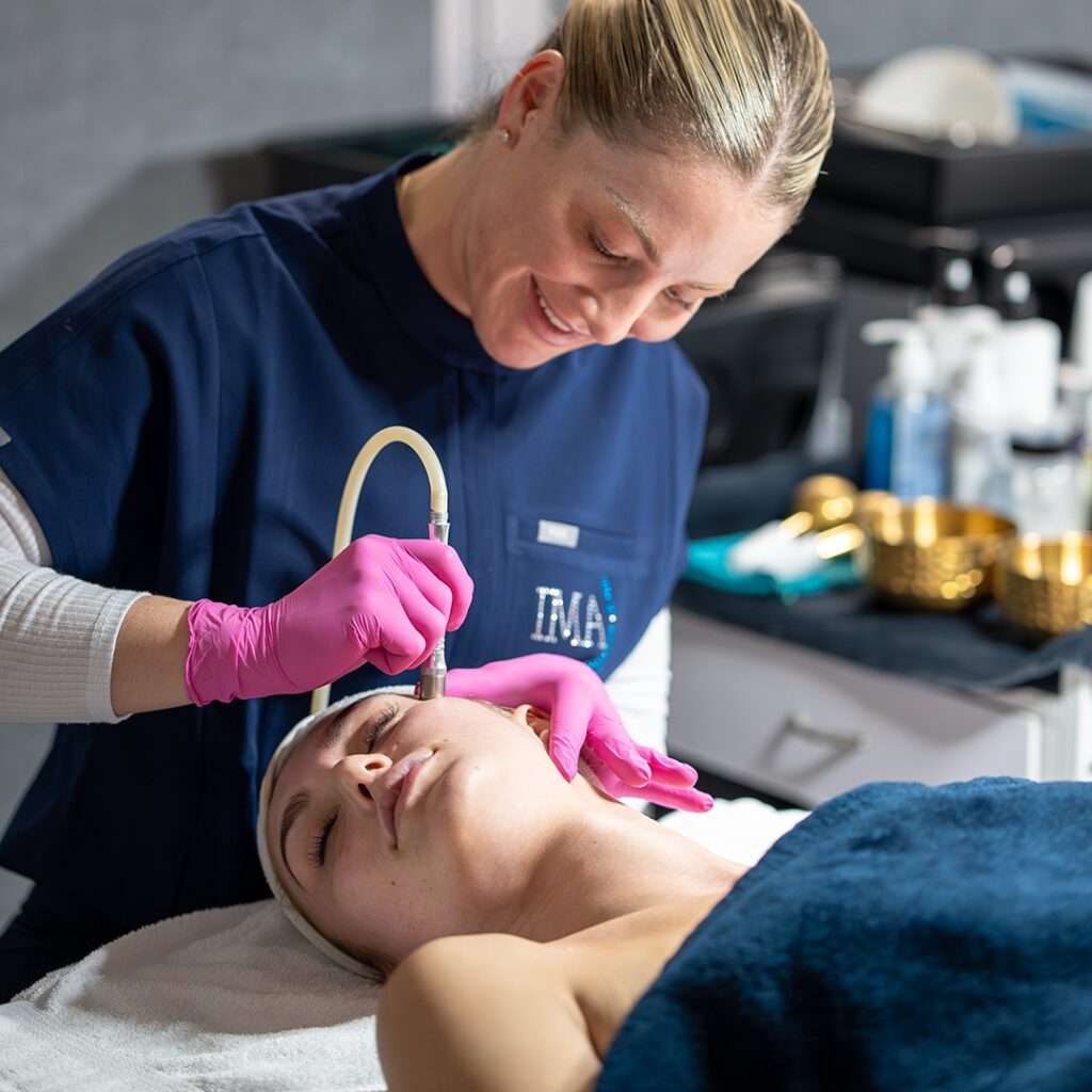 A client at IMAJ Institute receiving aesthetics treatment from a student